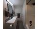 Modern bathroom featuring a white vanity, black fixtures, and a walk-in shower at 201 Ravenna N St, Nokomis, FL 34275