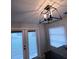 Dining room with modern, caged pendant light fixture and sliding doors to the yard at 201 Ravenna N St, Nokomis, FL 34275