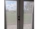 View through screen patio doors to fenced backyard and lawn at 201 Ravenna N St, Nokomis, FL 34275