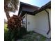 Exterior detail of home with well maintained stucco and dark trim at 201 Ravenna N St, Nokomis, FL 34275