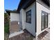 Side of home with AC unit and french doors to the backyard at 201 Ravenna N St, Nokomis, FL 34275