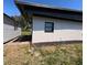 Side exterior view of the home and shed, showing the well-kept grounds and mulch beds at 201 Ravenna N St, Nokomis, FL 34275