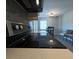 Close-up of a kitchen featuring white counters and dark appliances and a view to the eat-in area at 201 Ravenna N St, Nokomis, FL 34275