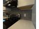 Close-up of modern kitchen backsplash, countertops, and appliances at 201 Ravenna N St, Nokomis, FL 34275