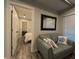 Living room features a sofa with decorative pillows and a framed mirror at 201 Ravenna N St, Nokomis, FL 34275