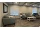 Inviting living room with wood floors and comfortable seating under beamed ceiling at 201 Ravenna N St, Nokomis, FL 34275