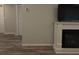 Living room showcasing modern fireplace, TV, and doorways leading to other rooms at 201 Ravenna N St, Nokomis, FL 34275