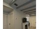Living space boasting modern gray ceiling beams and a decorative fireplace with TV at 201 Ravenna N St, Nokomis, FL 34275