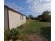 Outbuilding with a window on a well-maintained lawn adding additional storage or workspace to the property at 201 Ravenna N St, Nokomis, FL 34275