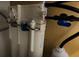 Close-up of plumbing connections and filtration unit under sink at 201 Ravenna N St, Nokomis, FL 34275