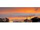 Beautiful sunset over rooftops with orange, yellow and pink clouds at 201 Ravenna N St, Nokomis, FL 34275