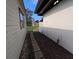 View of the yard showing the main home and outbuilding connected with a mulched walkway at 201 Ravenna N St, Nokomis, FL 34275