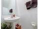 Cozy half bath with pedestal sink and neutral paint at 36495 Garden Wall Way, Zephyrhills, FL 33541