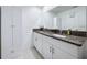 Bathroom with granite countertops, dual sinks, and a storage cabinet at 36495 Garden Wall Way, Zephyrhills, FL 33541