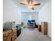 Upstairs bedroom with ceiling fan; ideal as home office or flex space at 36495 Garden Wall Way, Zephyrhills, FL 33541