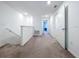 Upstairs hallway featuring neutral carpet, white walls, and natural light at 36495 Garden Wall Way, Zephyrhills, FL 33541