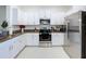 Modern kitchen with stainless steel appliances, white cabinets, and granite countertops at 36495 Garden Wall Way, Zephyrhills, FL 33541