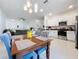 Open-concept dining and kitchen area with modern fixtures and a view to the living room at 36495 Garden Wall Way, Zephyrhills, FL 33541