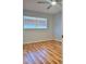 An empty bedroom showcasing wood-look floors and ample natural light from a large window at 5521 80Th Street North # 306, St Petersburg, FL 33709