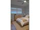 A cozy bedroom featuring a wood-look floor, neutral decor, and a large window for natural light at 5521 80Th Street North # 306, St Petersburg, FL 33709