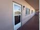 Condo exterior featuring a glass door, outside hallway, and stucco exterior walls at 5521 80Th Street North # 306, St Petersburg, FL 33709