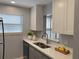 Kitchen featuring quartz countertops, stainless steel sink, and ample cabinet space at 5521 80Th Street North # 306, St Petersburg, FL 33709