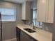 Kitchen featuring quartz countertops, stainless steel sink, and ample cabinet space at 5521 80Th Street North # 306, St Petersburg, FL 33709