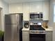 A modern kitchen with stainless steel appliances, sleek white cabinets, and stylish countertop at 5521 80Th Street North # 306, St Petersburg, FL 33709