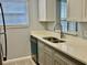 A contemporary kitchen with stainless steel appliances, updated cabinets, and a view from the window at 5521 80Th Street North # 306, St Petersburg, FL 33709
