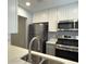 Modern kitchen featuring stainless steel appliances and white cabinetry at 5521 80Th Street North # 306, St Petersburg, FL 33709