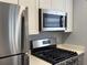 Kitchen featuring stainless steel microwave, gas range, and refrigerator at 5521 80Th Street North # 306, St Petersburg, FL 33709
