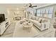 A beautifully staged living and dining area with neutral tones, modern furniture, and ample natural light at 5521 80Th Street North # 306, St Petersburg, FL 33709