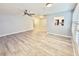 A bright living room boasting new wood-look flooring and an open layout with view to the kitchen at 5521 80Th Street North # 306, St Petersburg, FL 33709