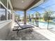Covered patio with lounge chair, perfect for relaxing by the screened-in pool at 11433 Alachua Creek Ln, Riverview, FL 33579