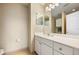Well-lit bathroom featuring a white vanity with dual mirrors, ample counter space, and tiled flooring at 116 S Obrien St, Tampa, FL 33609