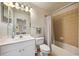 Bright bathroom featuring a white vanity, framed mirror, and a shower with tan tile surround at 116 S Obrien St, Tampa, FL 33609