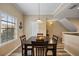 The warm dining room features a dark wood table for four with a window offering natural light at 116 S Obrien St, Tampa, FL 33609