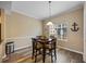 Inviting dining area with a dark wood table set for four, complemented by a window with natural light at 116 S Obrien St, Tampa, FL 33609