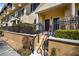 Charming entrance with stairs, dark doors, decorative wrought iron fencing, and manicured shrubs at 116 S Obrien St, Tampa, FL 33609