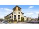 Charming condo complex featuring a stucco facade, tower accents, and well-maintained landscaping at 116 S Obrien St, Tampa, FL 33609