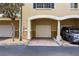 Attached garage with brick driveway and a parked gray SUV at 116 S Obrien St, Tampa, FL 33609