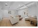 Bright living room featuring coffered ceilings, hardwood floors, and neutral-colored furniture at 116 S Obrien St, Tampa, FL 33609