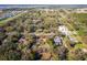 Aerial perspective of a home featuring a private pool, nestled in a vibrant neighborhood with mature trees at 32589 Greenwood Loop, Wesley Chapel, FL 33545