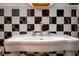 Modern black and white bathroom featuring vanity with contemporary sink and hardware at 32589 Greenwood Loop, Wesley Chapel, FL 33545