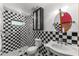 Modern black and white bathroom featuring glass enclosed shower, tiled walls, and contemporary fixtures at 32589 Greenwood Loop, Wesley Chapel, FL 33545