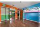 Vibrant bedroom featuring colorful murals, hardwood floors, and a lofted bed at 32589 Greenwood Loop, Wesley Chapel, FL 33545