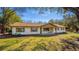 Inviting single-story home showcasing a covered front porch with a swing and well-maintained front yard at 32589 Greenwood Loop, Wesley Chapel, FL 33545