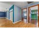 Hallway with wood floors and multiple doorways at 32589 Greenwood Loop, Wesley Chapel, FL 33545