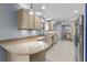Well-lit kitchen with tile flooring, granite countertops, and stainless steel appliances at 32589 Greenwood Loop, Wesley Chapel, FL 33545