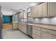 Well-equipped kitchen with stainless steel appliances and view into the living room at 32589 Greenwood Loop, Wesley Chapel, FL 33545